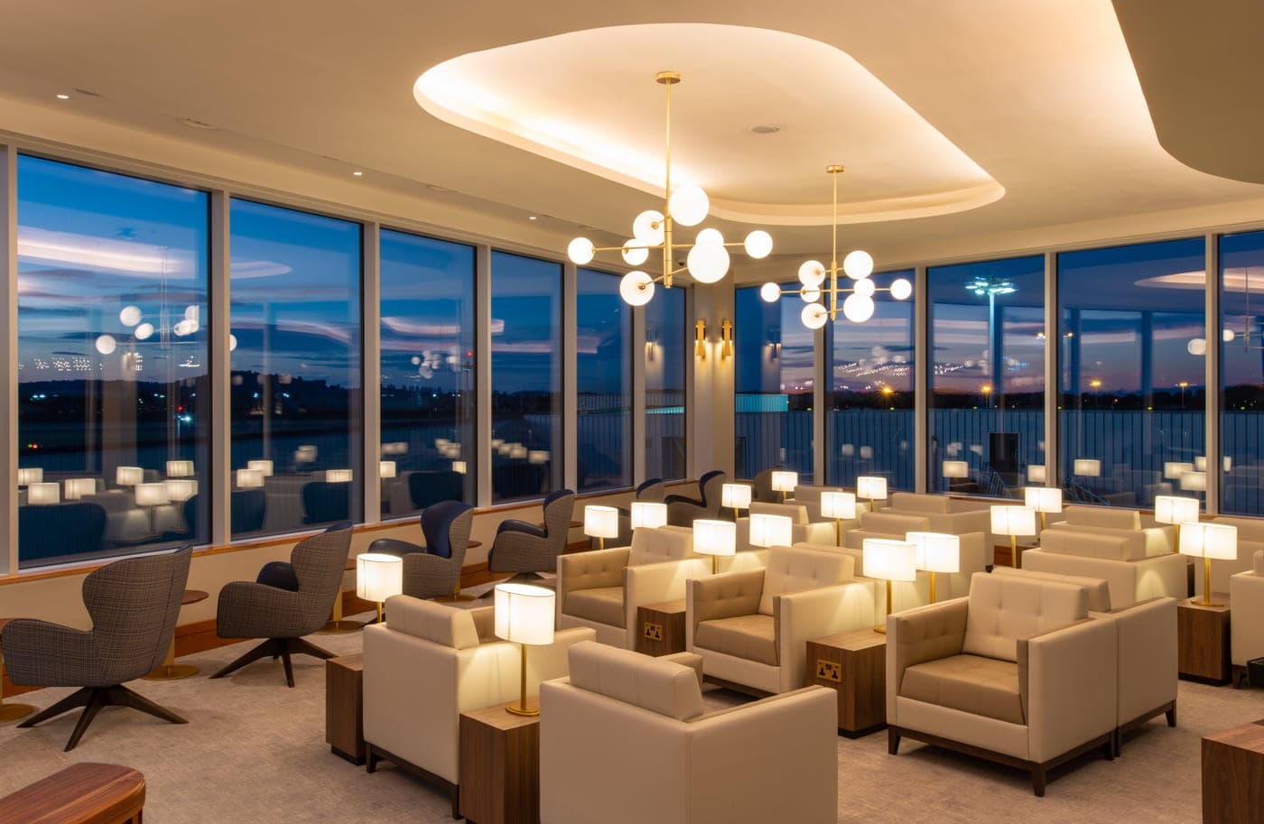 A comfortable airport lounge with chargers in the chairs